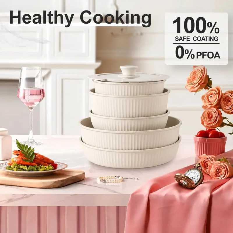 cream-detachable-handle-cookware-healthy-cooking cream detachable-handle cookware set with five ribbed pots and pans stacked on a kitchen counter.