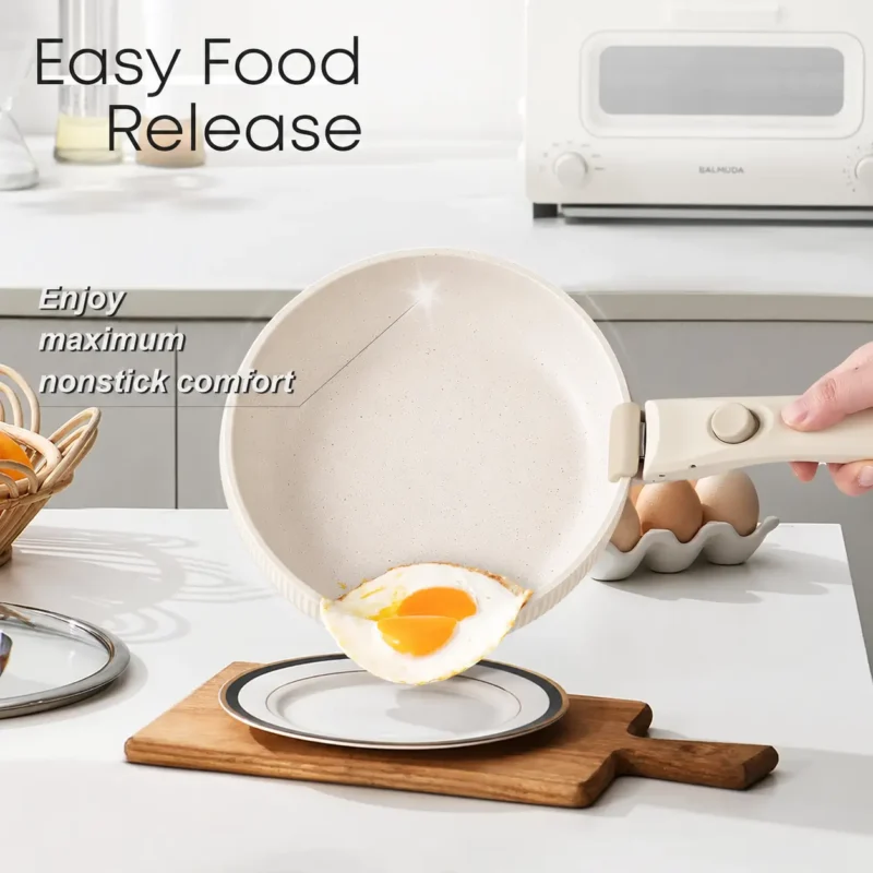 cream-nonstick-frying-pan-food-release Cream nonstick frying pan with a detachable handle releasing a fried egg onto a plate.